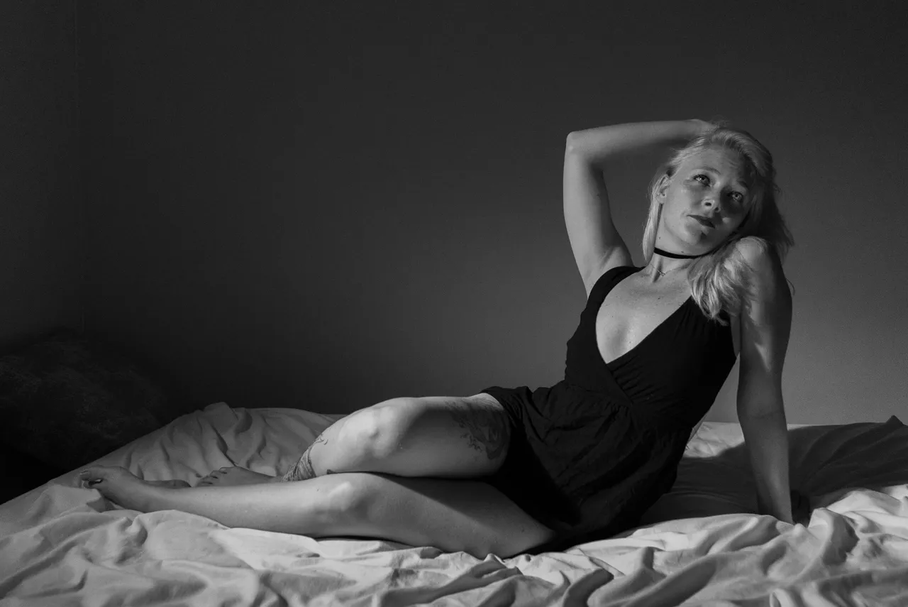 Elegant Semi Nude girl posing for boudoir photography on bed 