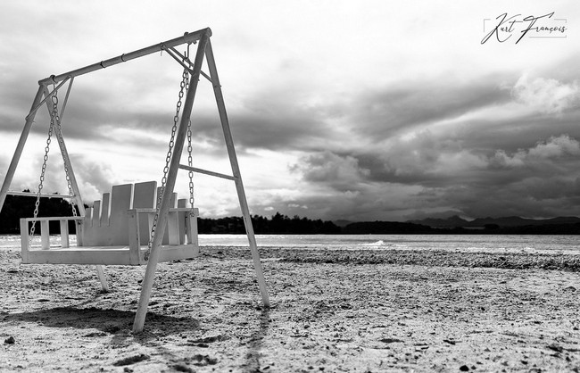 Black and white photo of swing on the beach of Ile des deux Cocos Mauritius